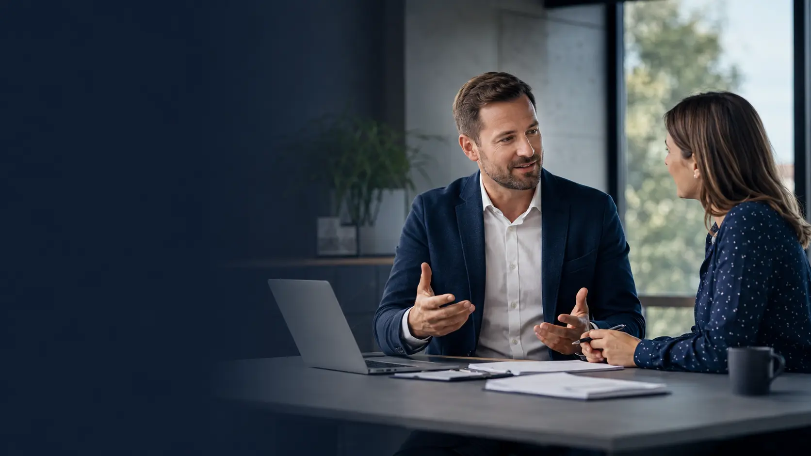 Man and woman discussing commercial vehicle leasing at a desk